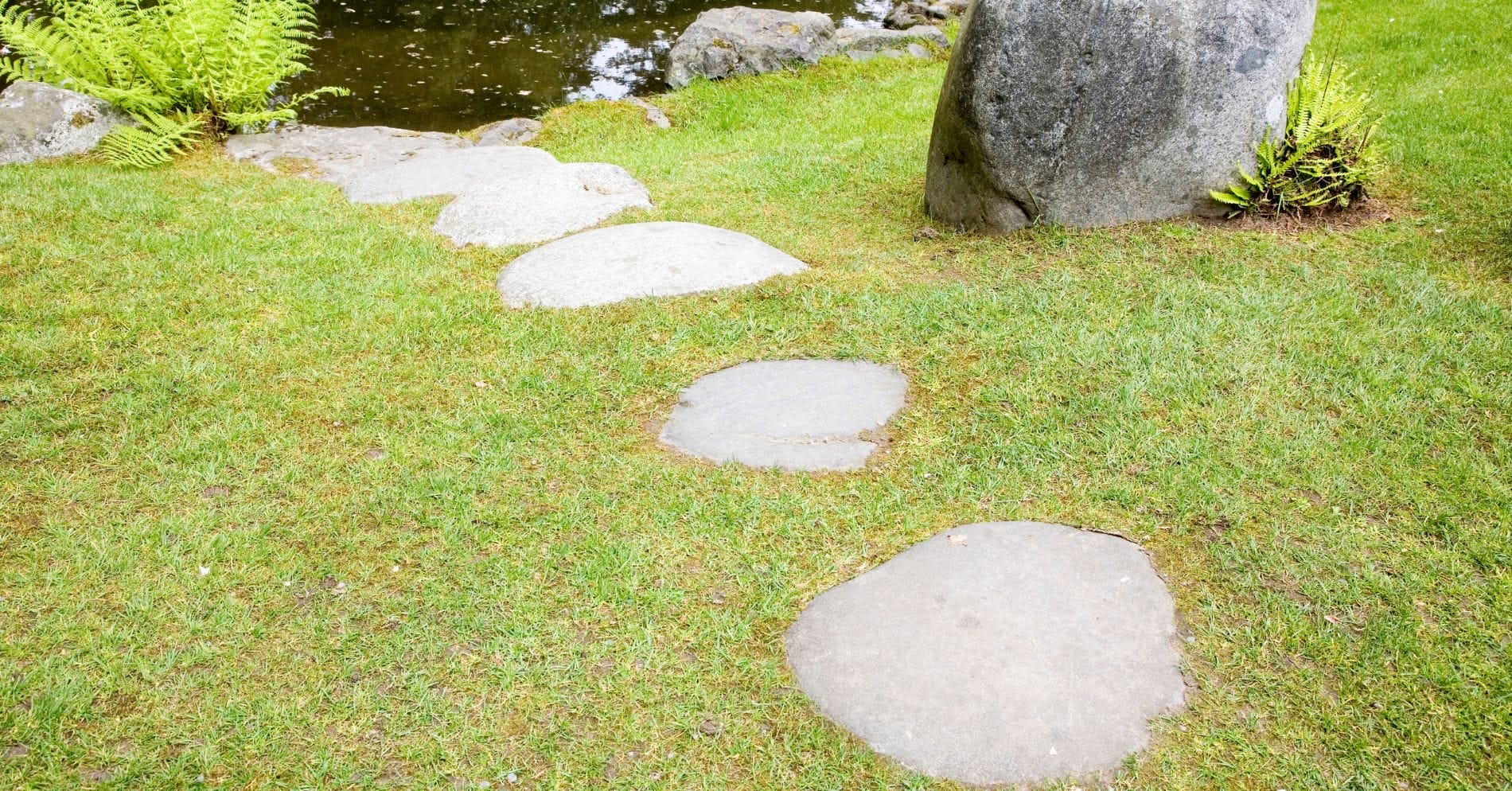 Stepping stones going towards a pond